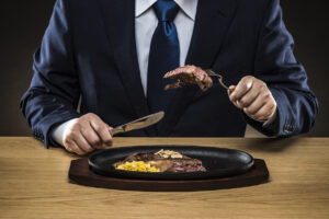 Businessman eating steak